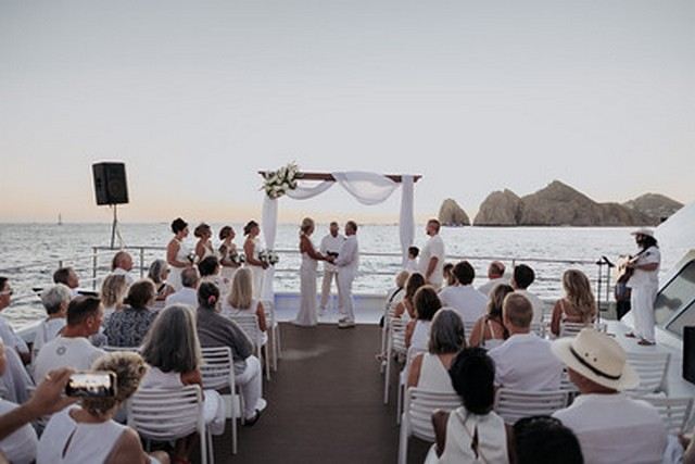 Wedding guests seated on a catamaran deck in Cabo San Lucas