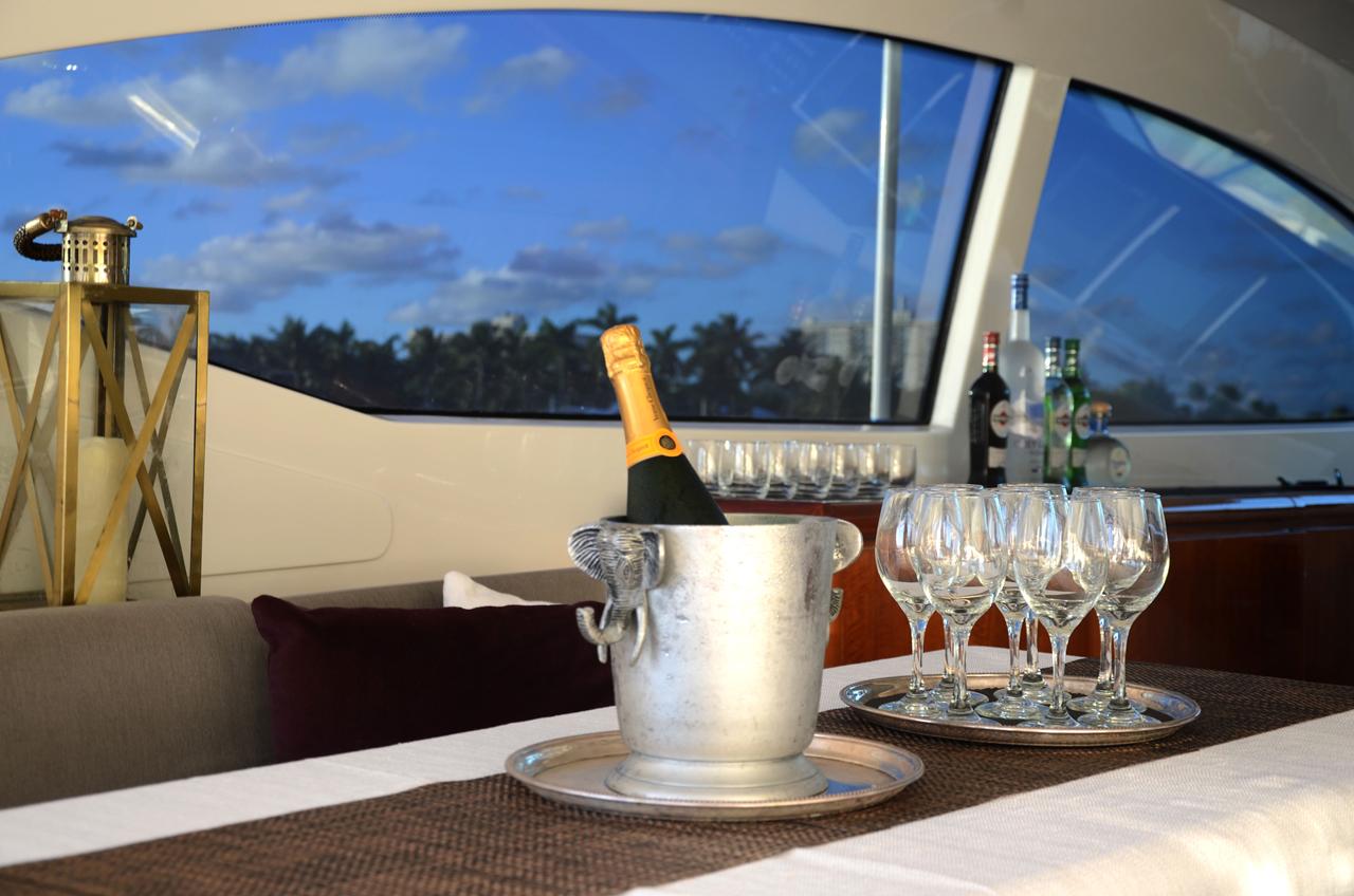 Champagne on ice and glasses set out inside a yacht's salon