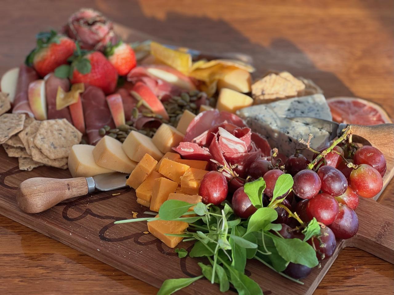 A charcuterie and fruit board prepared aboard a catamaran