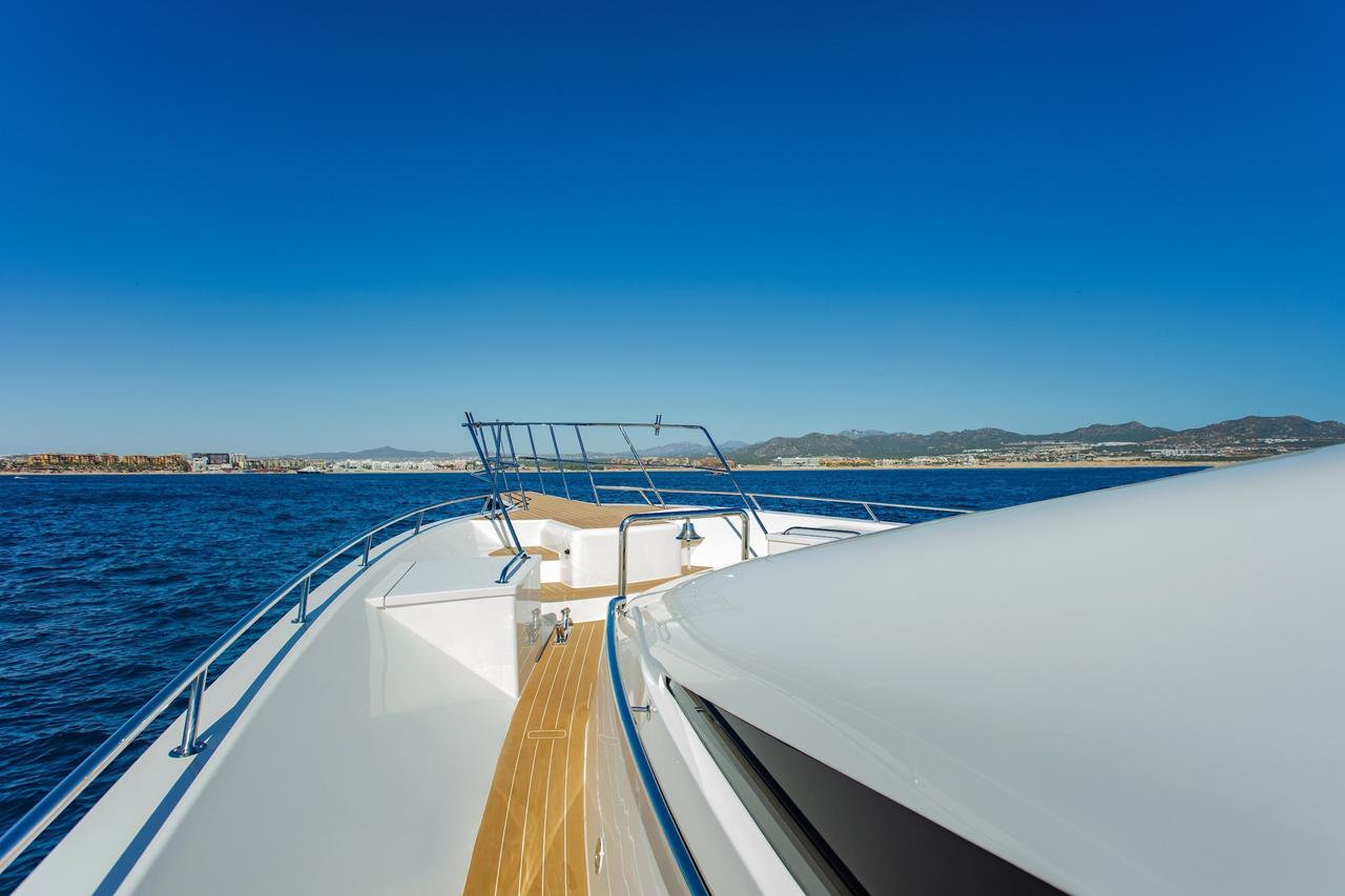 The foredeck of a large motor yacht heading out to open sea