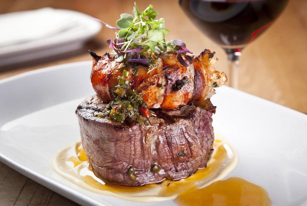 A plated steak dinner served on board a private yacht