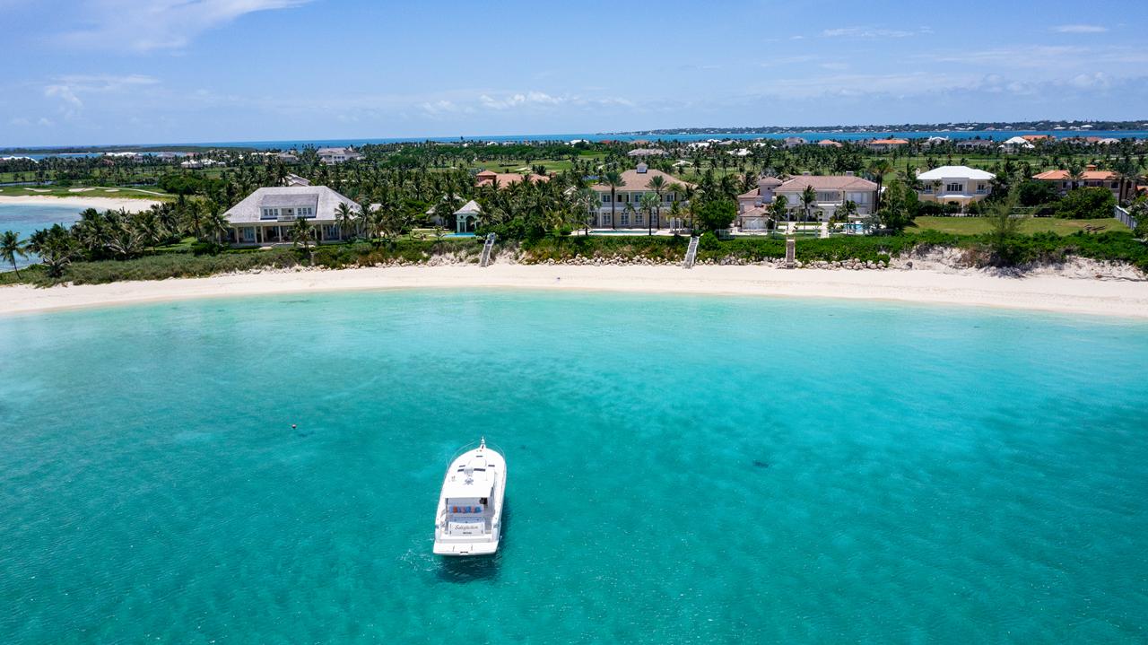 A motor yacht anchored off a white-sand beach near Paradise Island in Nassau, Bahamas