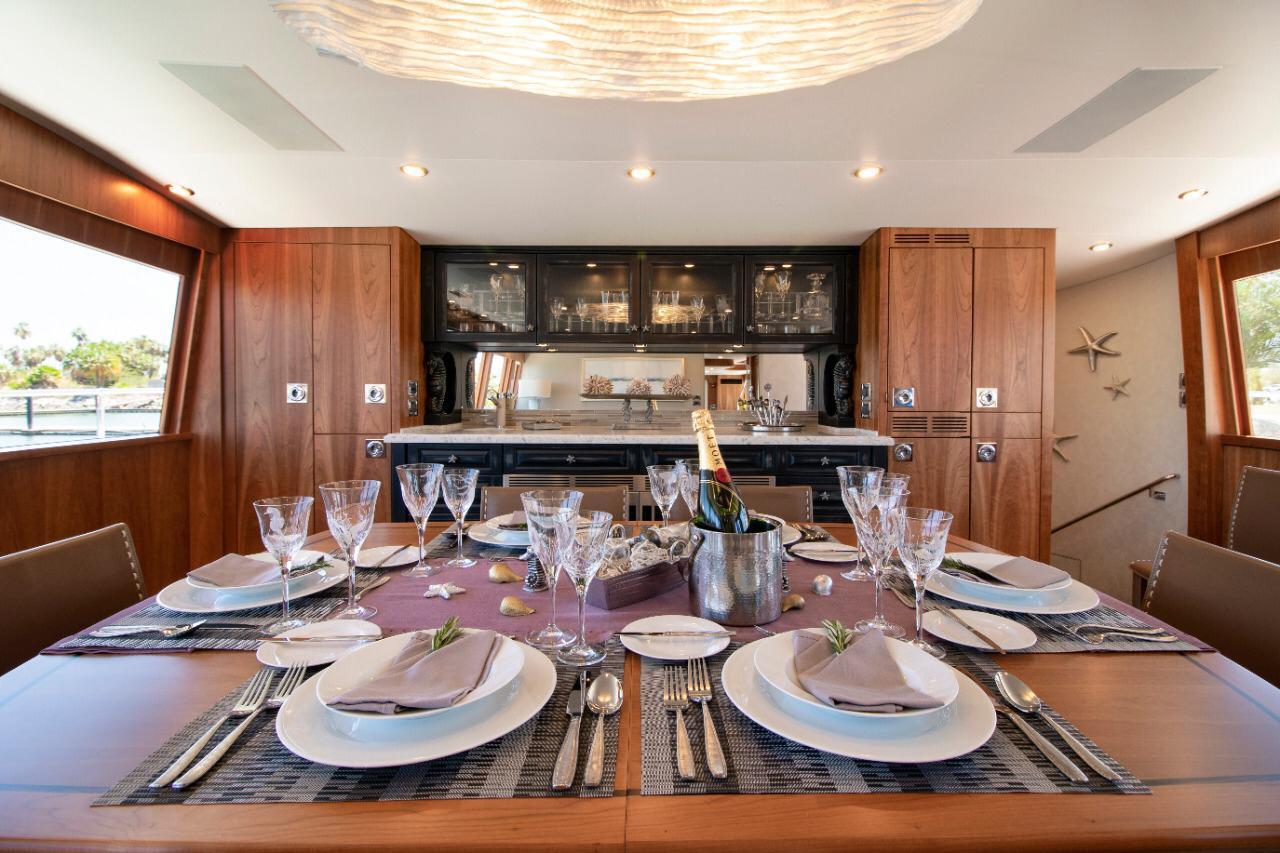 A formal dining table set inside a luxury motor yacht