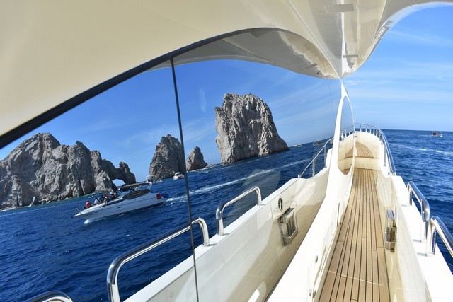 Sea and sky reflected in the hull windows of a yacht under way